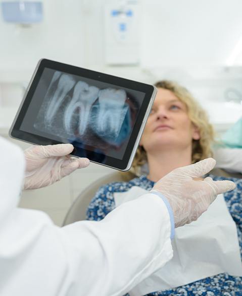 Dentist discussing digital x-rays with dental patient